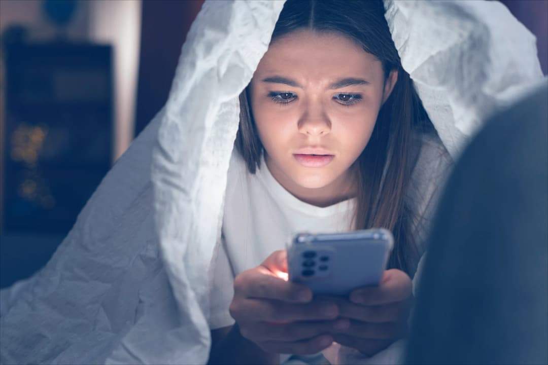 Person distracted by multiple digital devices