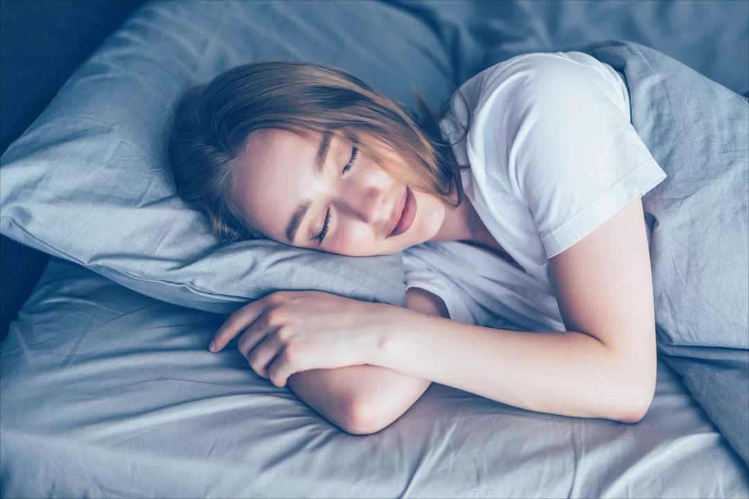 Person sleeping peacefully in a comfortable bed